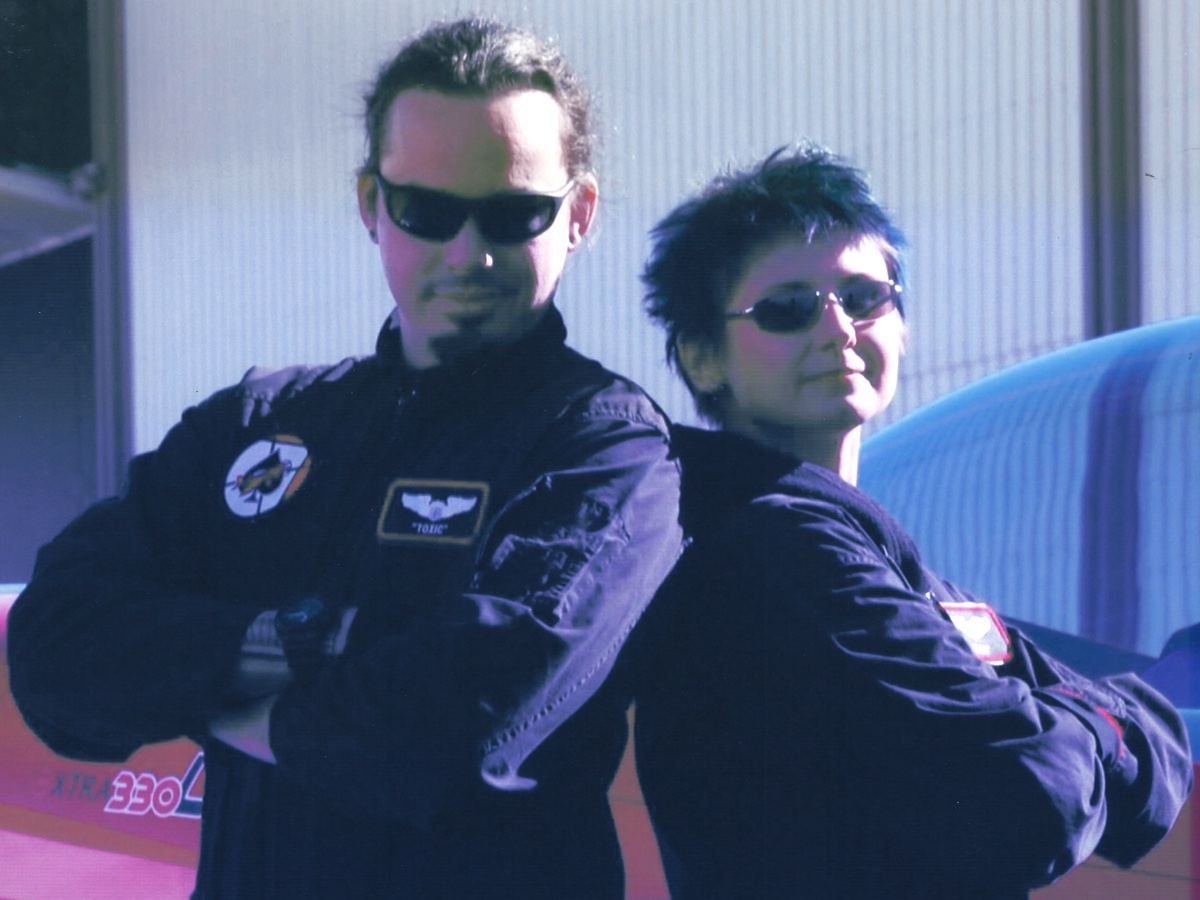 Adrian and Lisa in front of an Extra 330 stunt plane